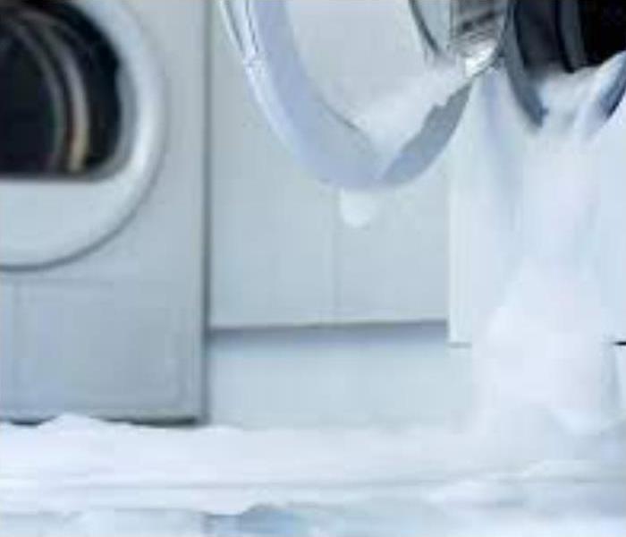 Washing machine overflowing with suds